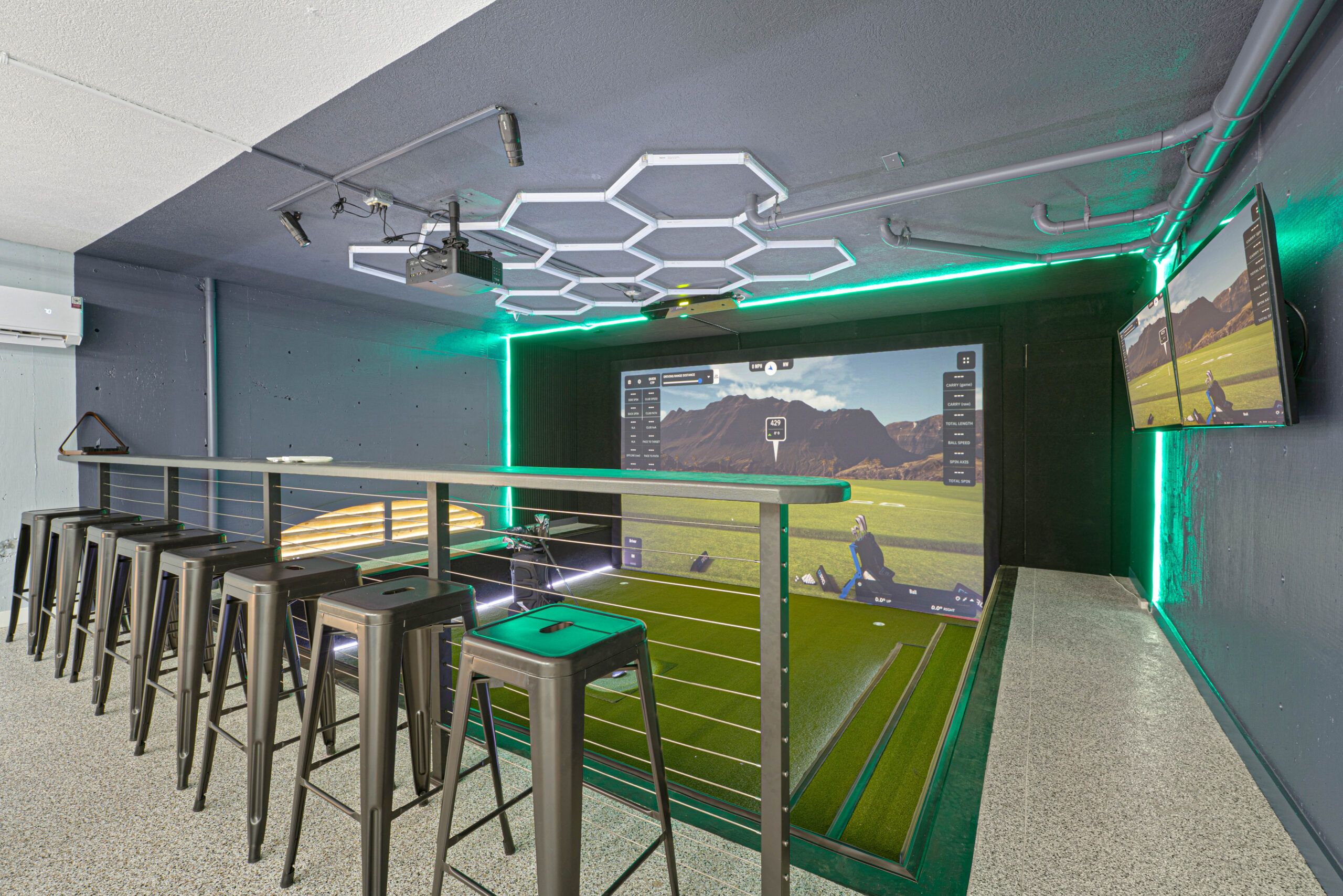 In-home golf simulator with bar-height seating and hex lighting at the Hilton Head retreat estate