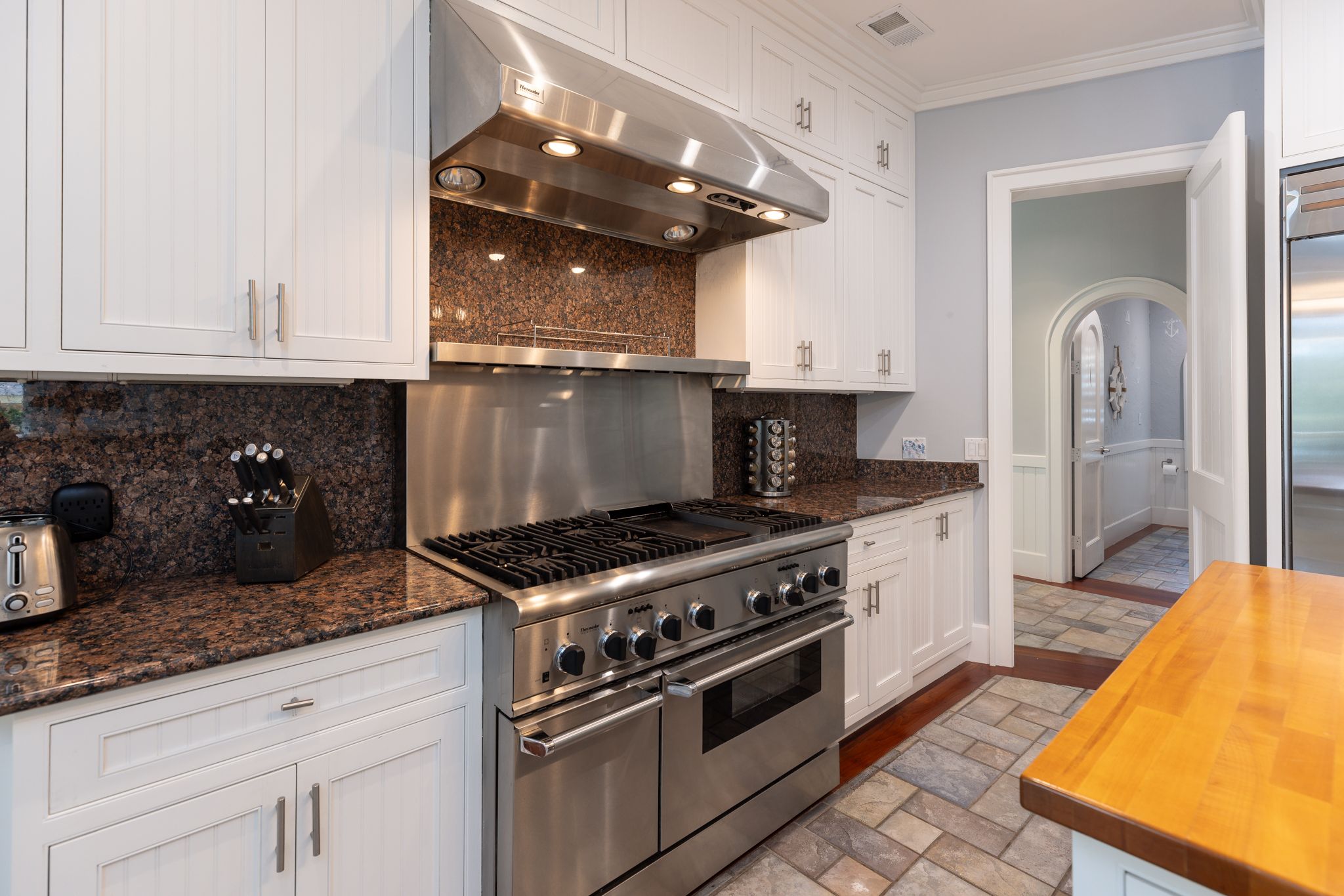Eight-burner range at the heart of the chef’s kitchen