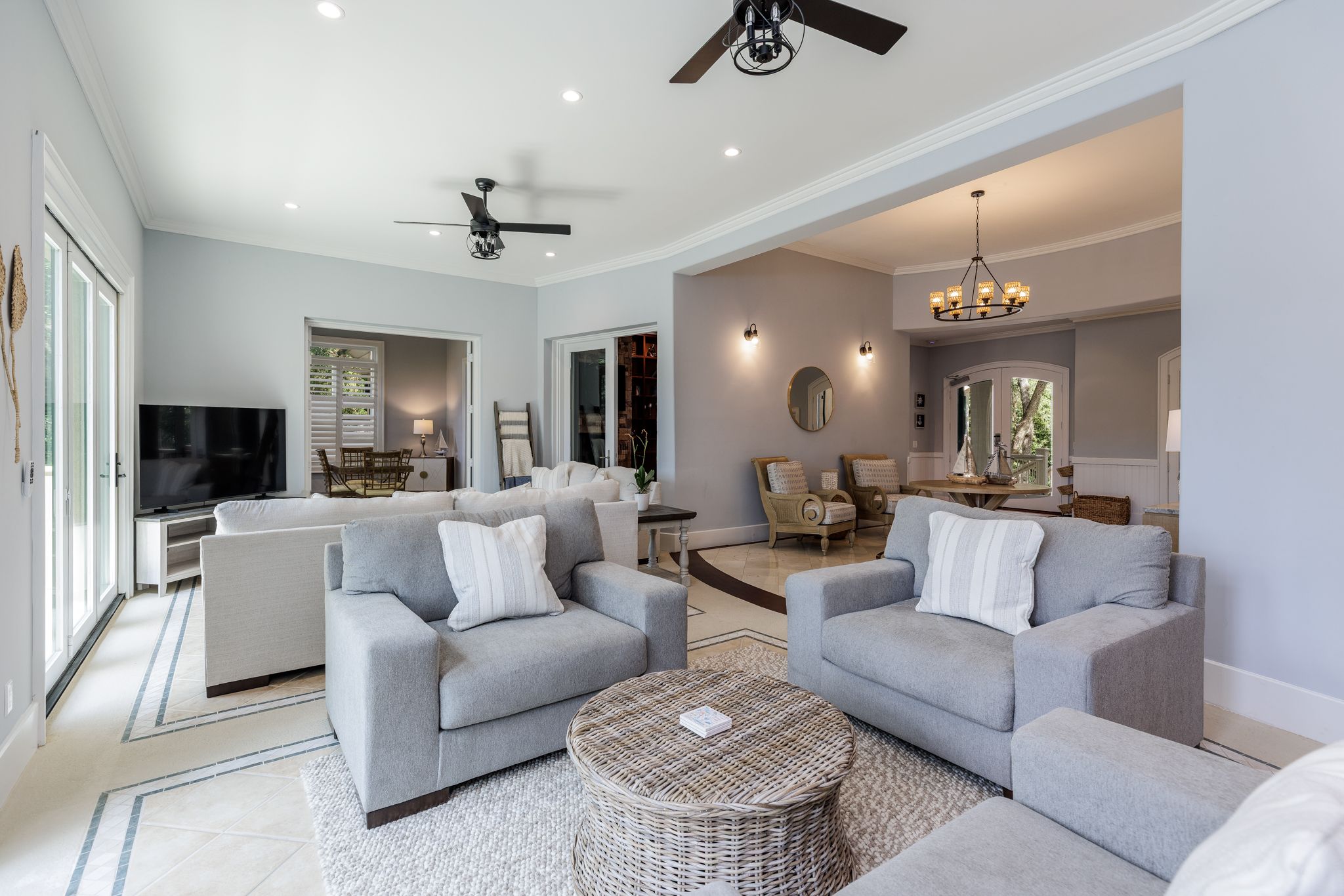 Wide great room with generous seating and a large screen for full-group leadership sessions at the estate