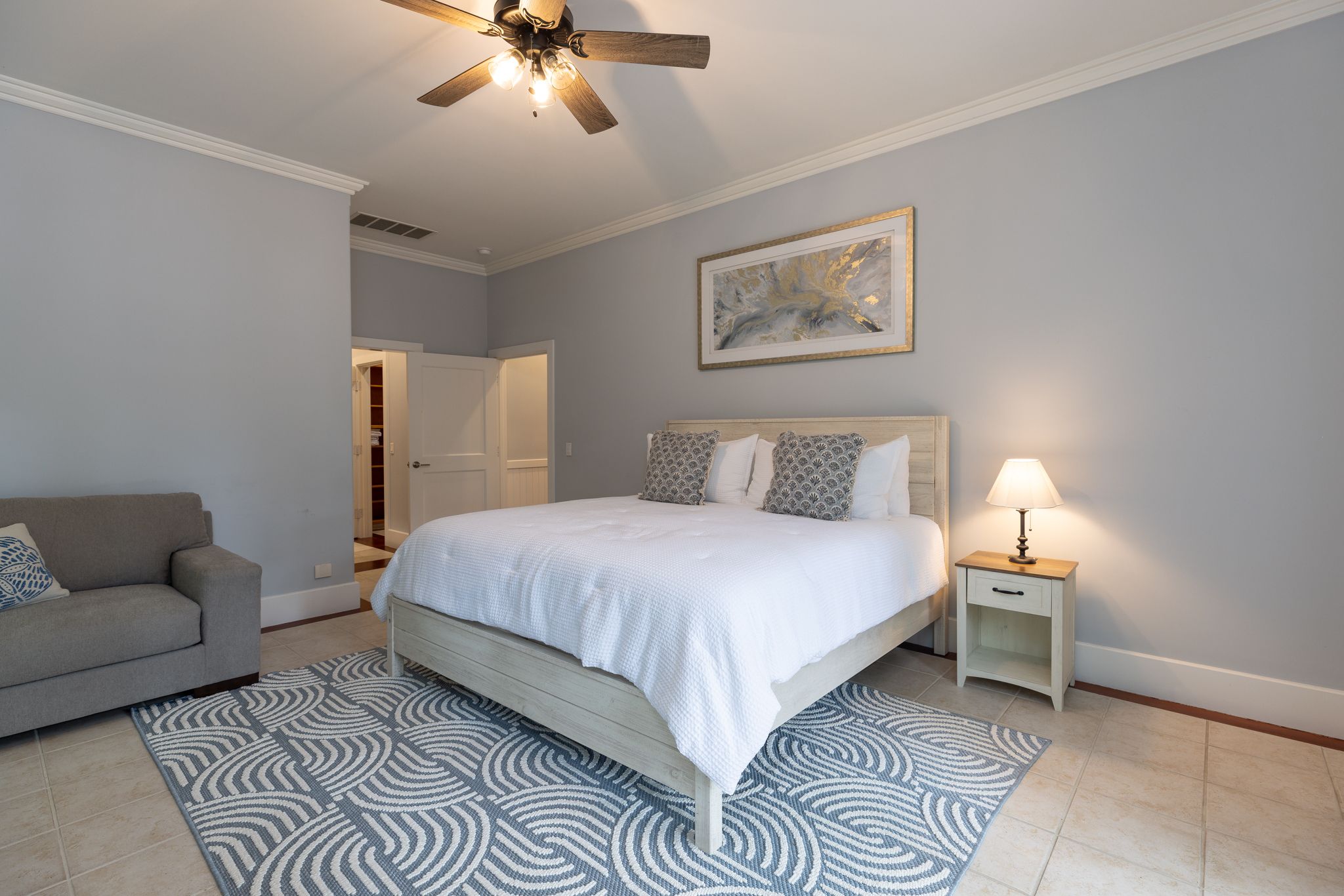 King suite with soft light and hardwood floors in one wing of the estate