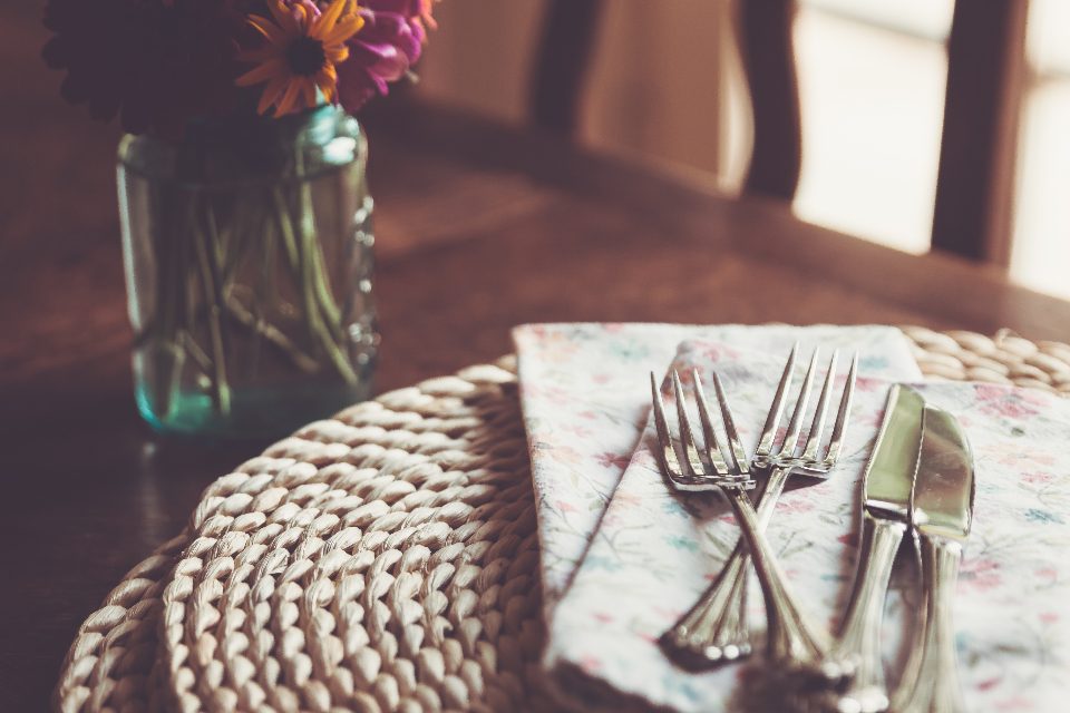 A long table set for a group dinner indoors.